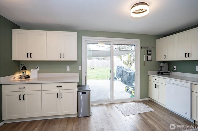 10103 Kline St SW, Lakewood, WA 98499 - kitchen featuring light wood-style flooring, white cabinetry, light countertops, and dishwasher