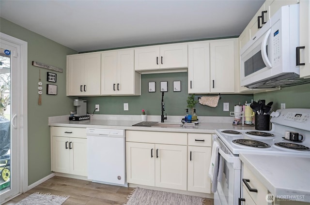 10103 Kline St SW, Lakewood, WA 98499 - kitchen featuring light countertops, white appliances, a sink, and white cabinetry