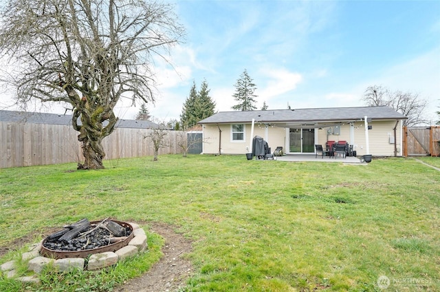 10103 Kline St SW, Lakewood, WA 98499 - rear view of property featuring a yard, a fenced backyard, a patio, and a fire pit