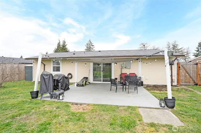 10103 Kline St SW, Lakewood, WA 98499 - rear view of house featuring a yard, a patio, fence, and a gate