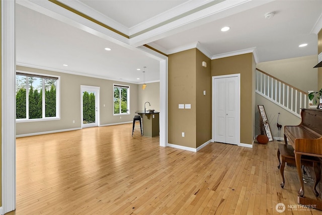 living room featuring crown molding, recessed lighting, stairway, light wood-style flooring, and baseboards