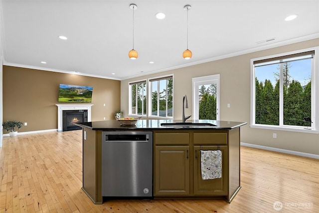 kitchen with dark countertops, visible vents, a sink, and a fireplace