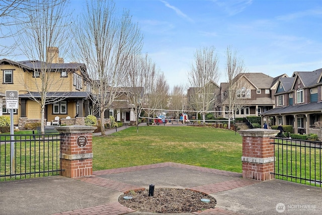 view of property's community featuring a residential view, fence, volleyball court, and a lawn