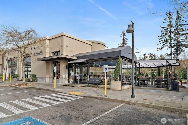 view of building exterior with uncovered parking