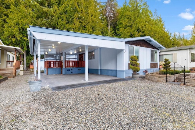 view of front of house with driveway and a carport