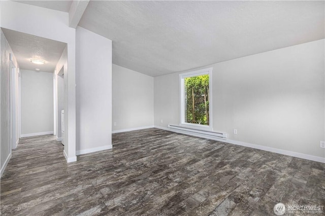 empty room featuring baseboards, a textured ceiling, a baseboard heating unit, and wood finished floors