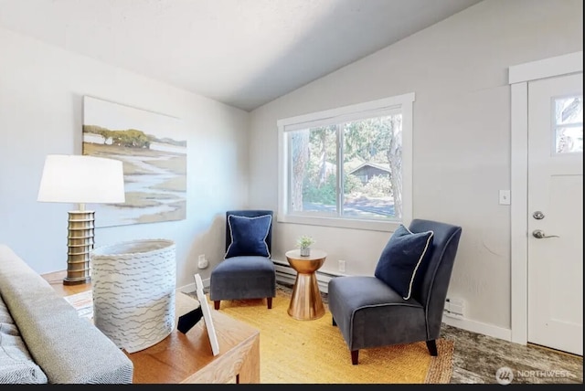 sitting room featuring lofted ceiling, baseboards, and baseboard heating