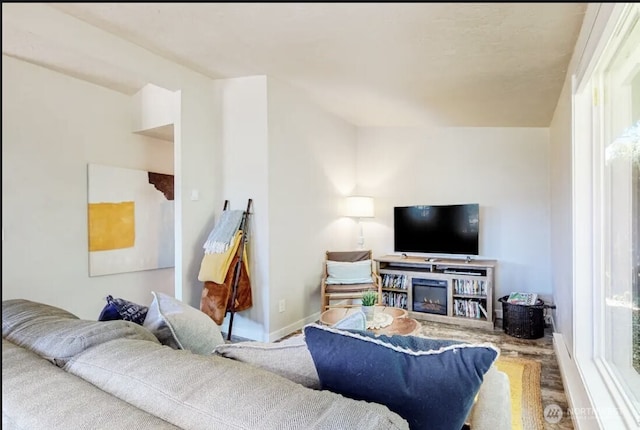 living area with plenty of natural light and baseboards