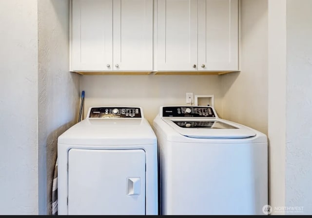 washroom featuring a textured wall and separate washer and dryer