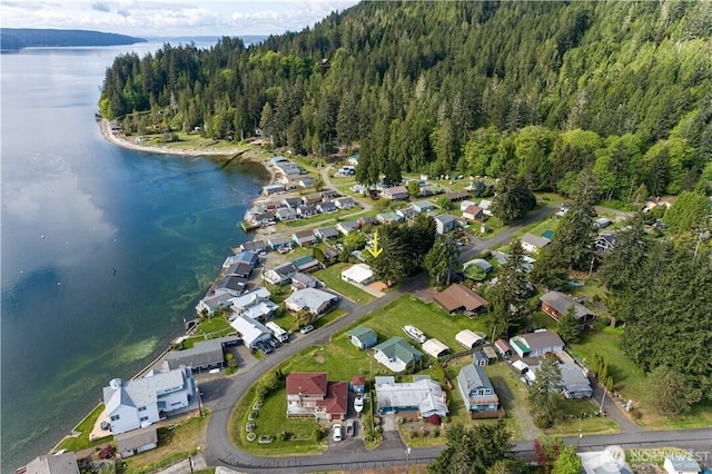 drone / aerial view with a water view, a residential view, and a wooded view