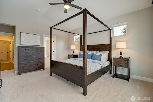 bedroom with baseboards, lofted ceiling, ceiling fan, and light colored carpet