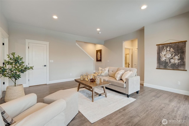 living room with recessed lighting, baseboards, and wood finished floors