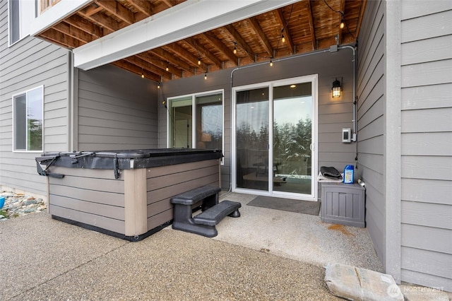entrance to property with a patio area and a hot tub