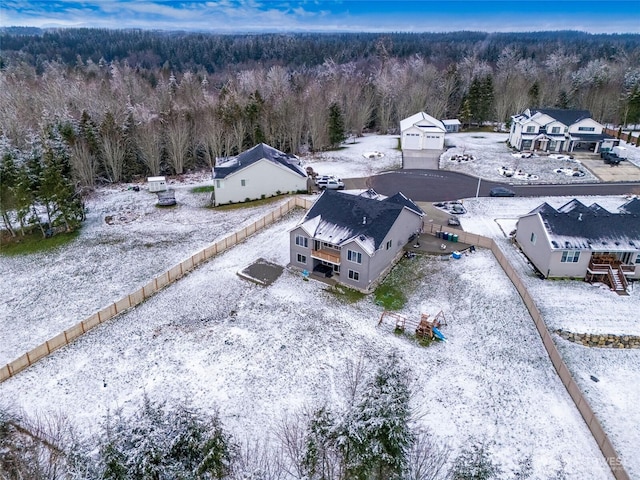 snowy aerial view with a forest view