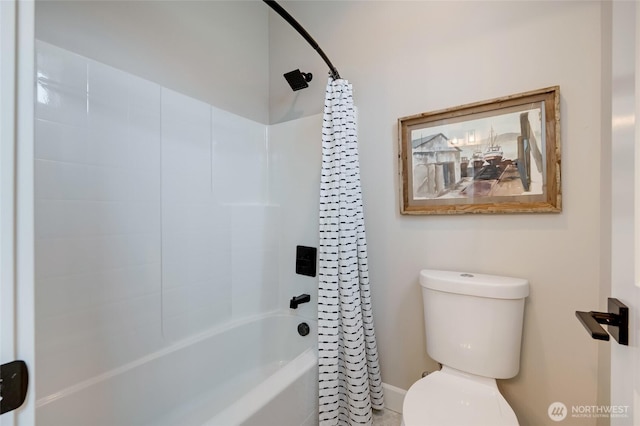 full bathroom featuring shower / bath combo with shower curtain and toilet