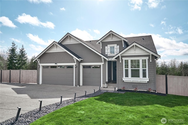 view of front of property with fence, an attached garage, driveway, a front yard, and a shingled roof