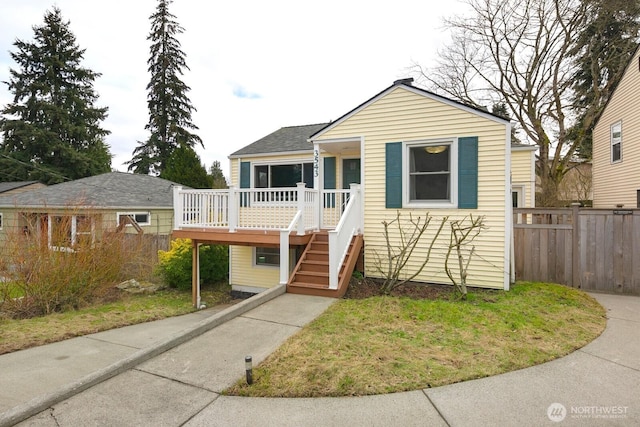 bungalow featuring stairway, fence, and a deck