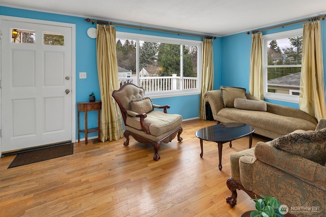 living area with light wood-style floors and baseboards