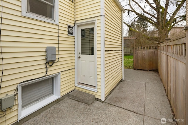 view of exterior entry featuring fence