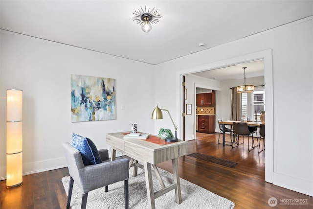 office area featuring baseboards, a chandelier, and wood finished floors