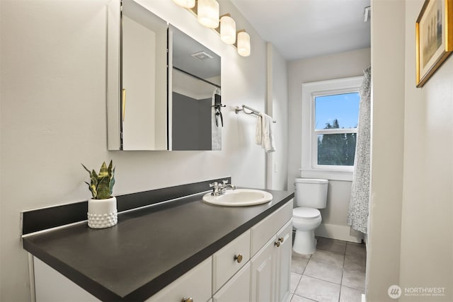 bathroom featuring curtained shower, vanity, toilet, and tile patterned floors