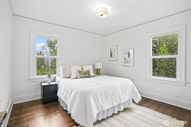 bedroom featuring dark wood-type flooring and baseboards