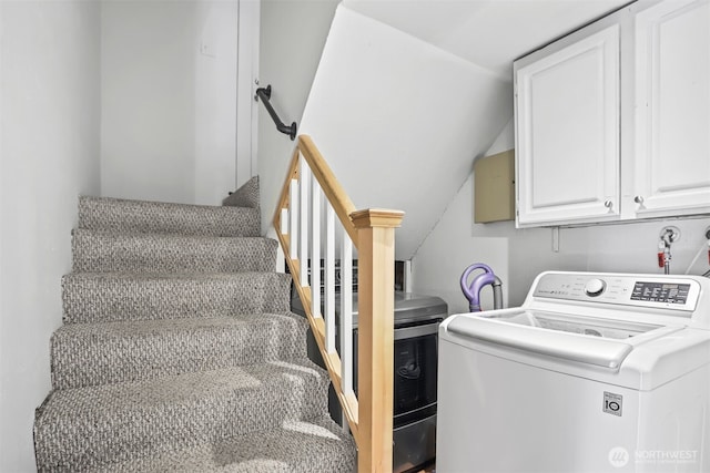 washroom featuring washer / dryer and cabinet space