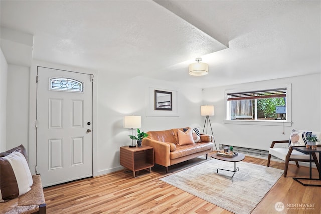 living area with a textured ceiling and wood finished floors