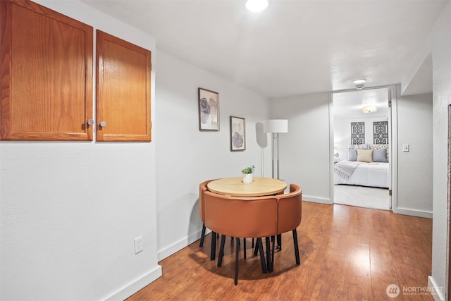 dining room featuring wood finished floors and baseboards