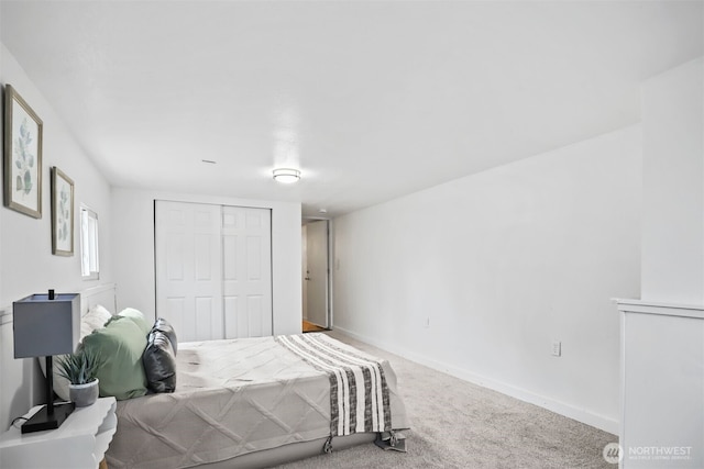 carpeted bedroom with baseboards and a closet