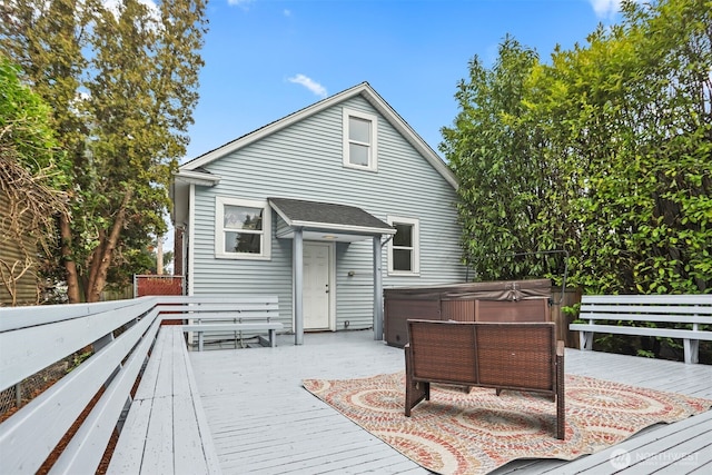 deck with fence and a hot tub