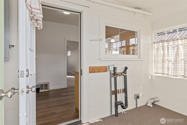 laundry area featuring laundry area, visible vents, and wood finished floors