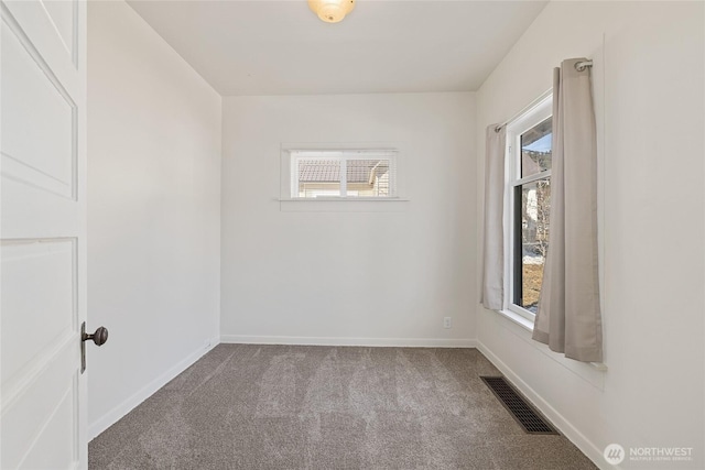 carpeted spare room with visible vents and baseboards