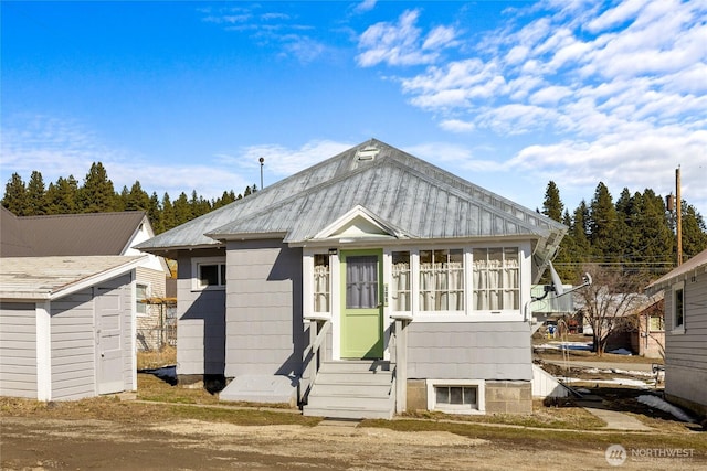 view of front of property featuring entry steps and an outbuilding