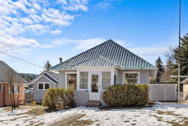 bungalow featuring entry steps and metal roof