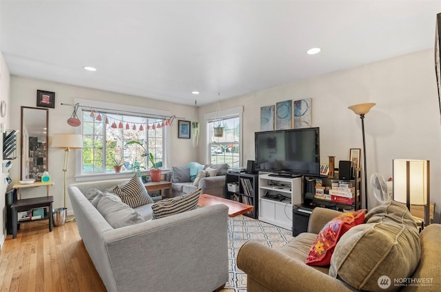 living area with light wood-style flooring and recessed lighting