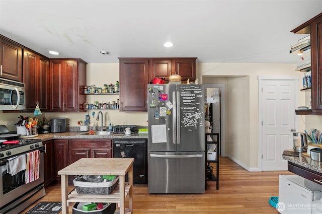 kitchen with appliances with stainless steel finishes, light wood-type flooring, open shelves, a sink, and recessed lighting