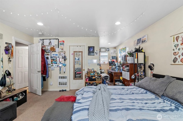 bedroom featuring baseboards and light colored carpet