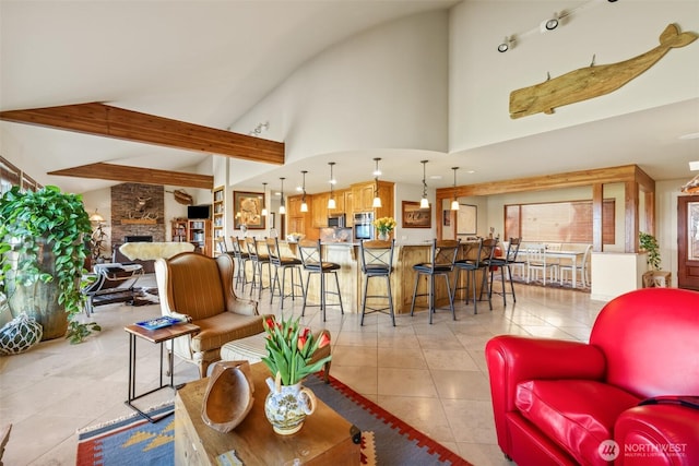 living room with light tile patterned floors, a fireplace, high vaulted ceiling, and beam ceiling