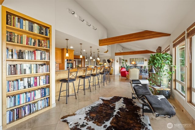 living room featuring vaulted ceiling with beams and light tile patterned floors