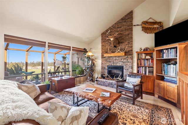 living room featuring high vaulted ceiling, a fireplace, and a sunroom