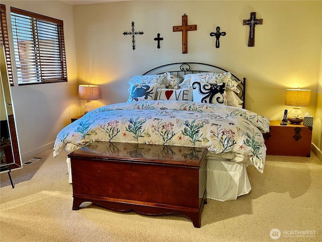 carpeted bedroom featuring visible vents and baseboards