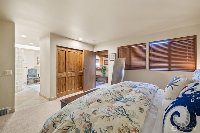 bedroom with carpet, baseboards, a closet, and recessed lighting