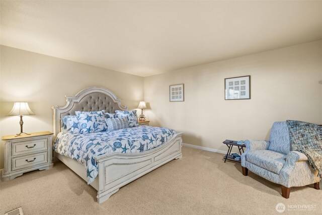 bedroom featuring light carpet and baseboards