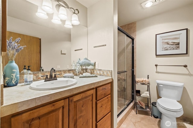 full bathroom featuring a stall shower, a notable chandelier, vanity, and toilet