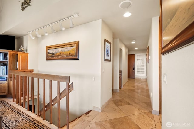 corridor featuring baseboards, light tile patterned floors, an upstairs landing, and recessed lighting