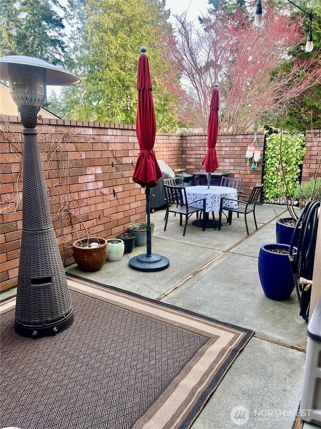 view of patio featuring outdoor dining area and a fenced backyard