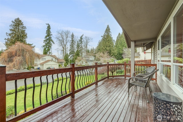 wooden terrace featuring a lawn