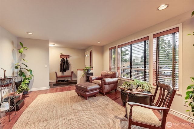 sitting room with wood finished floors, a wealth of natural light, and recessed lighting