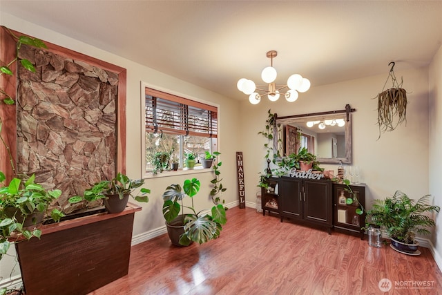 dining room with an inviting chandelier, baseboards, and wood finished floors